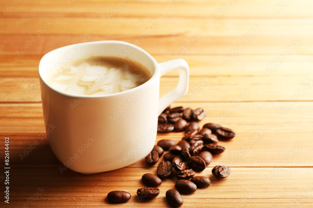 Cup of coffee latte art with grains on wooden background Cup of coffee latte art with grains on wooden background