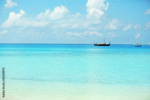 View of beautiful blue ocean water with ship in resort © Africa Studio