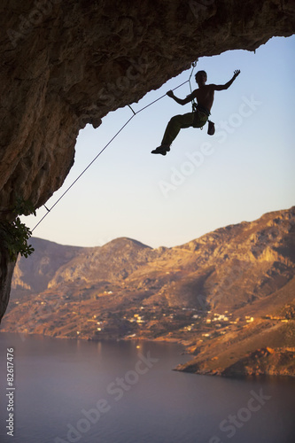 Male rock climber on overhanging cliff, Kalymnos Island, Greece