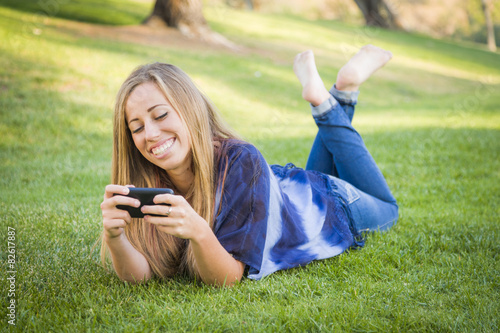 Smiling Young Woman Using C...