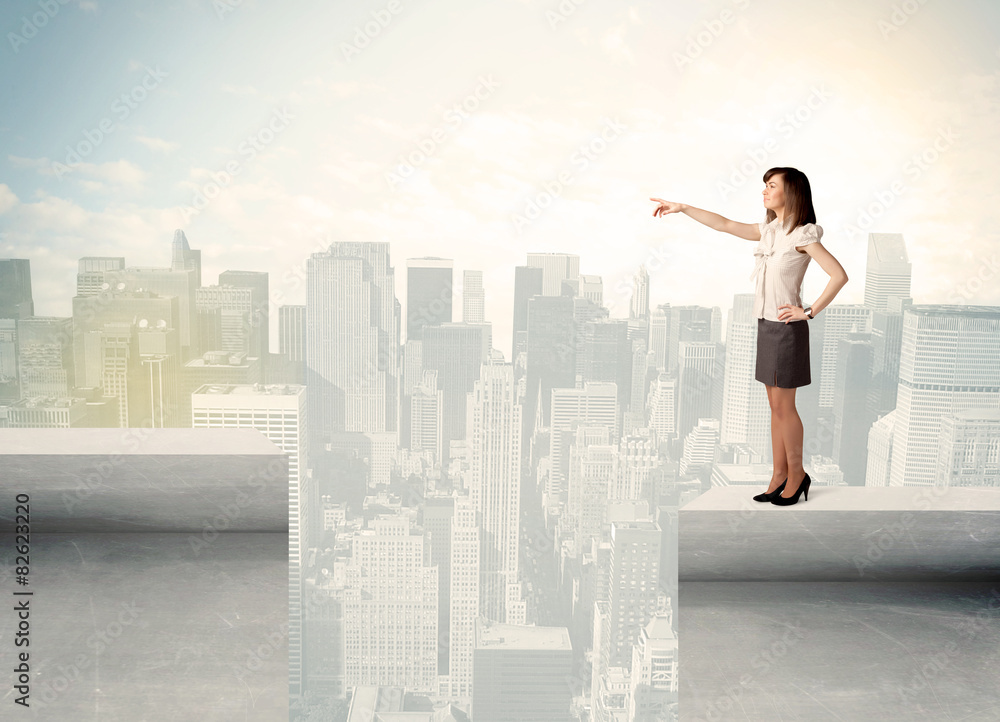 Businesswoman standing on the edge of rooftop