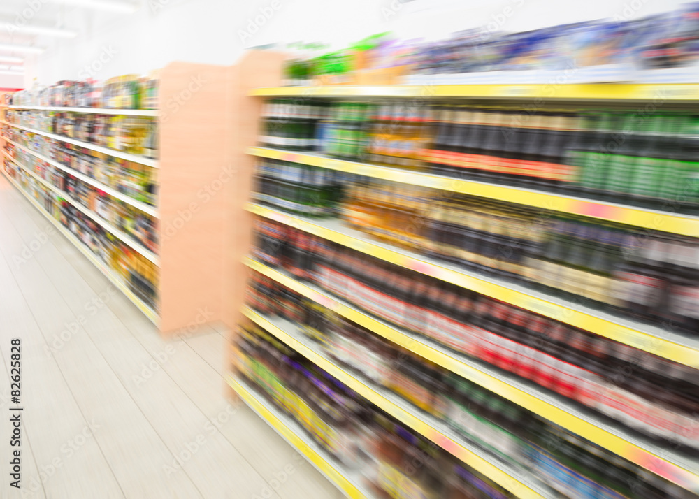 Shelves with beverages bottles in grocery food store supermarket