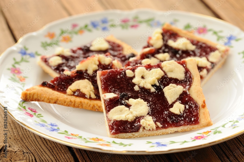Berry jam cookies in white plate on wooden background closeup Berry jam cookies in white plate on wooden background closeup