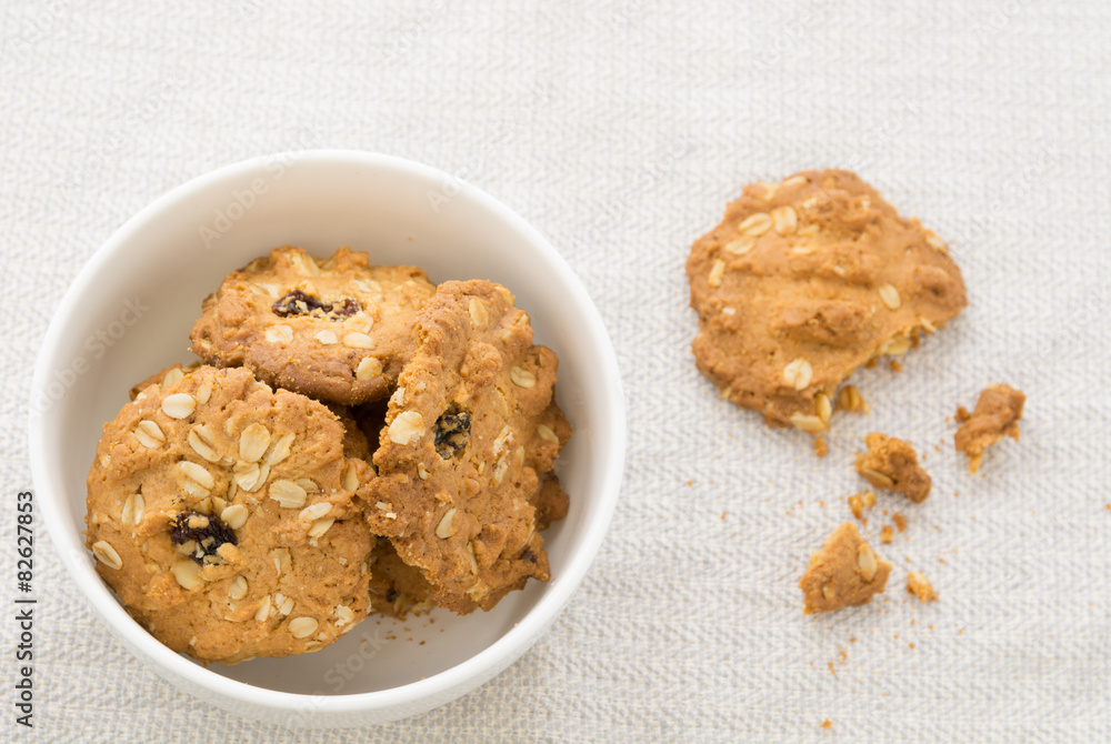 Cookies, cereals in white bowl With debris on the table. Cookies, cereals in white bowl With debris on the table.