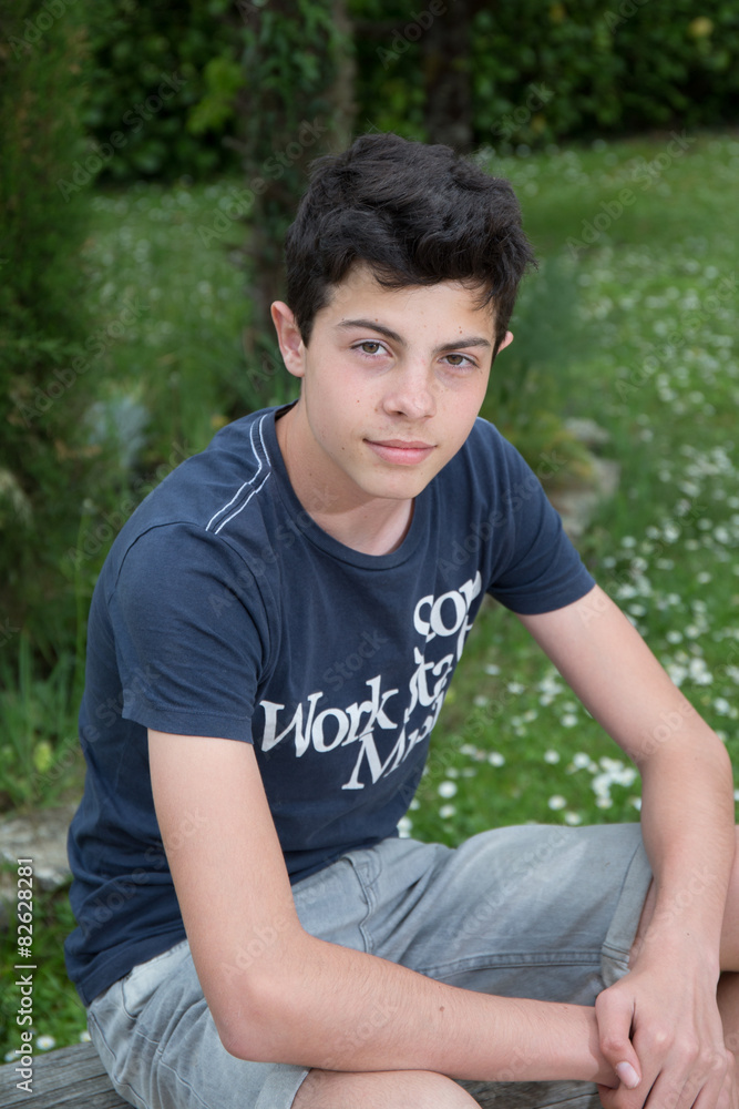Teenager is posing outside in the garden Teenager is posing outside in the garden