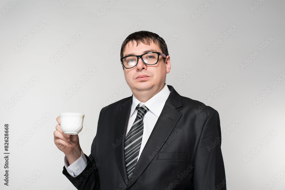 Young Business Man Drinking a Cup of Coffee or Tea Young Business Man Drinking a Cup of Coffee or Tea