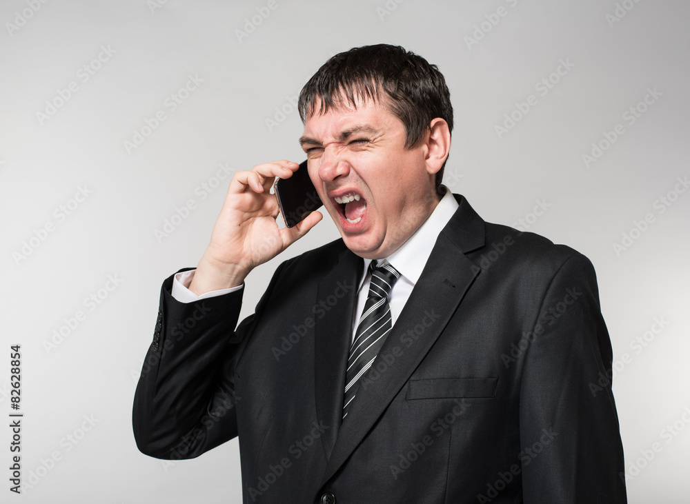 young businessman emotionally speaks on the phone young businessman emotionally speaks on the phone