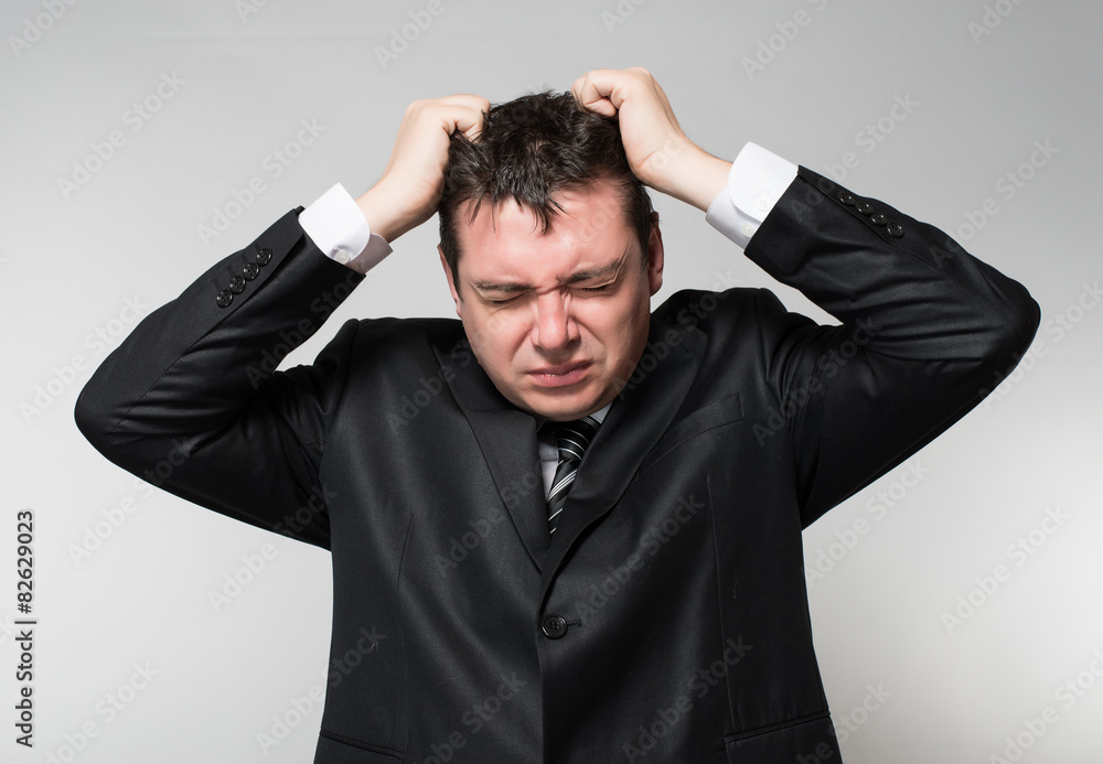 businessman in depression with hands on his head businessman in depression with hands on his head