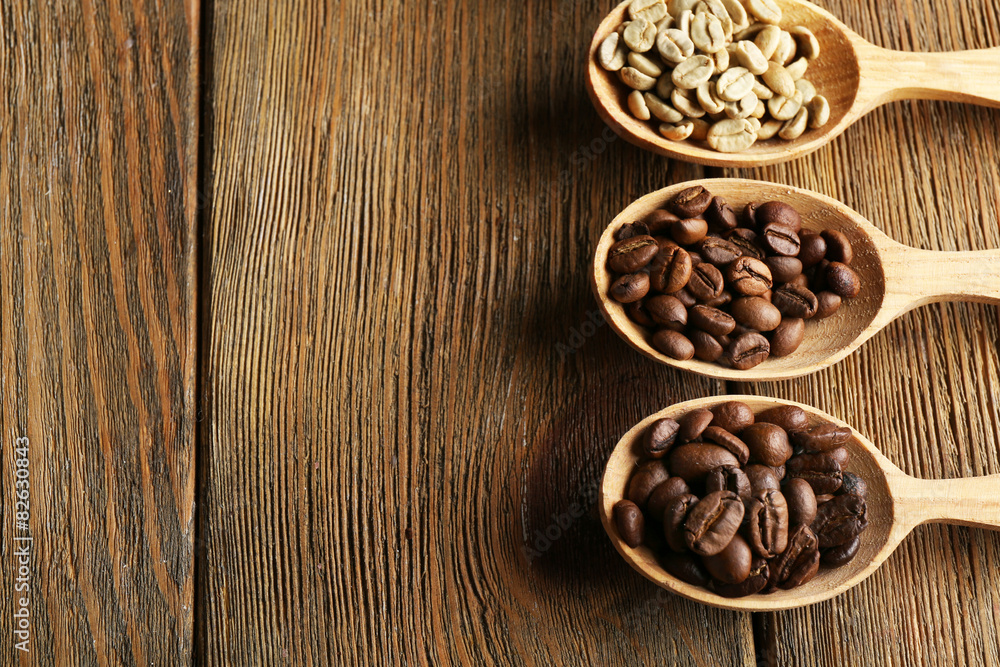 Coffee beans in spoons on wooden background Coffee beans in spoons on wooden background
