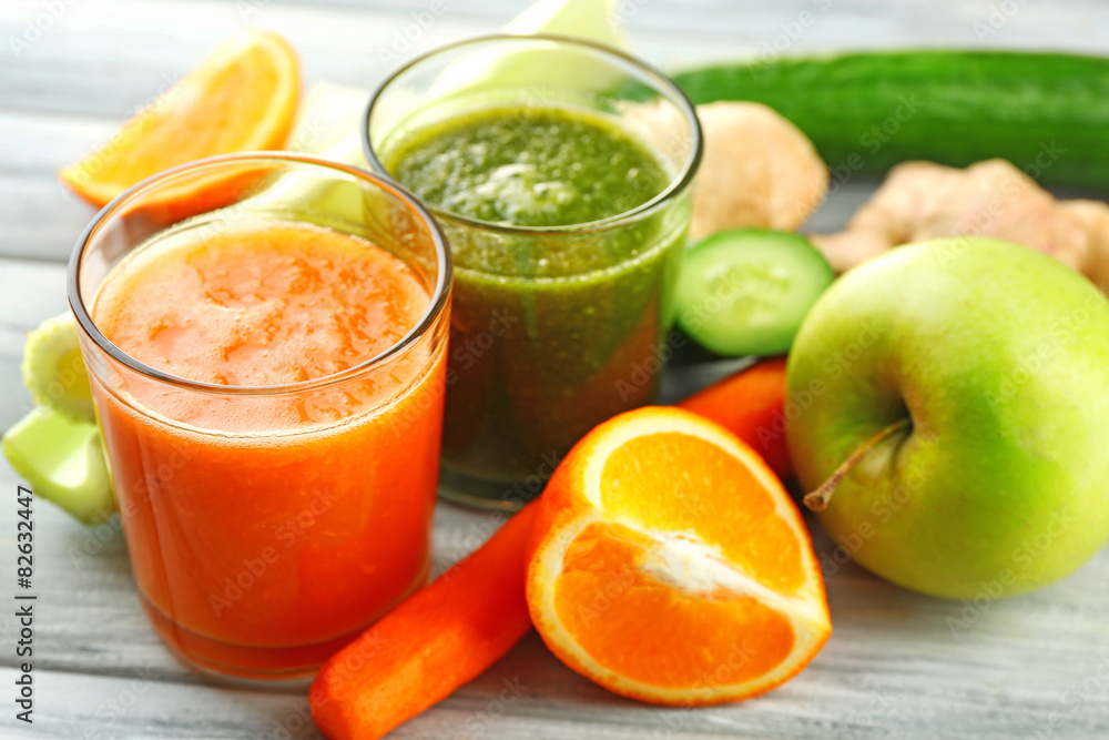 Assortment of healthy fresh juices on wooden table background Assortment of healthy fresh juices on wooden table background