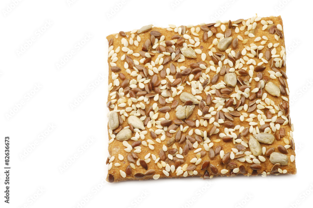 crispy spelt cracker with mixed seeds on a white background crispy spelt cracker with mixed seeds on a white background