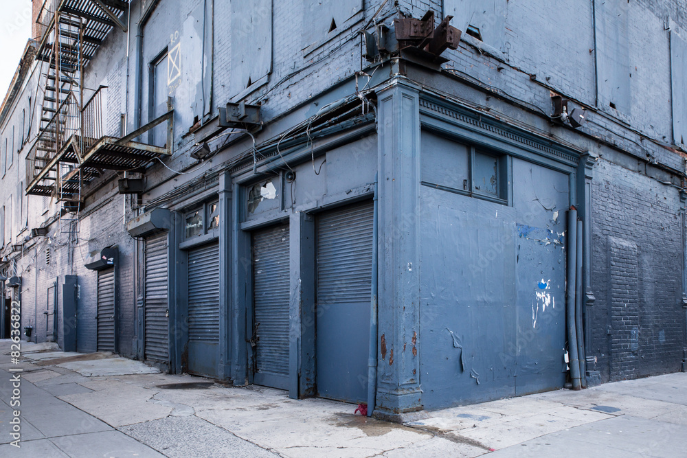 City street scene with abandoned weathered blue building