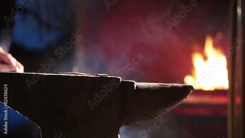 Blacksmith working on anvil photo