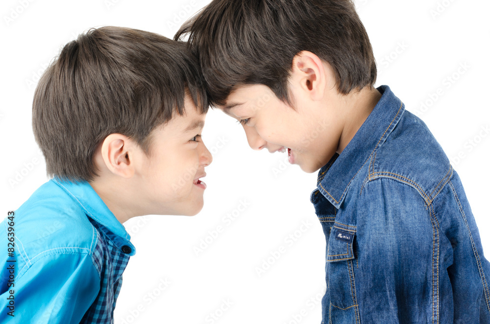 Little sibling boy fighting on white background Little sibling boy fighting on white background