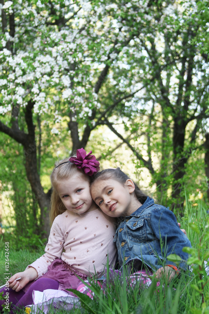 Girls sitting under spring tree Girls sitting under spring tree