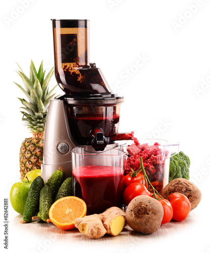 Foto Slow juicer with organic fruits and vegetables isolated on white