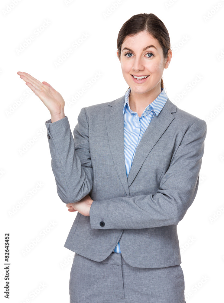 Brunette businesswoman with hand showing soemthing Brunette businesswoman with hand showing soemthing