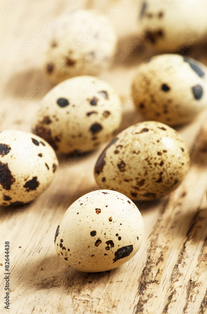 Quail eggs on a wooden table, selective focus