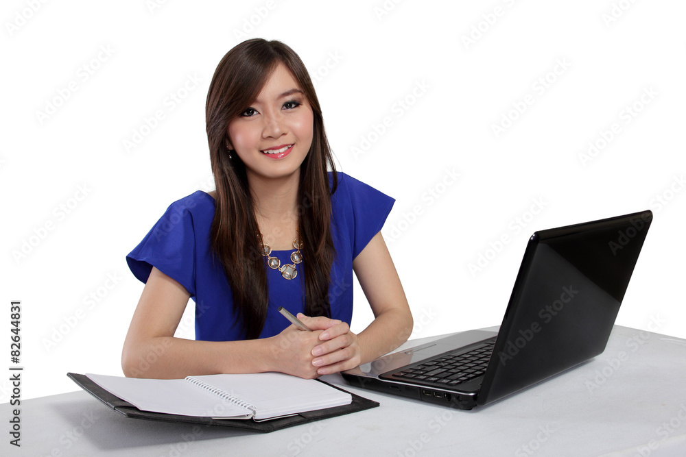 Young Asian woman sitting in front of laptop, isolated on white Young Asian woman sitting in front of laptop, isolated on white