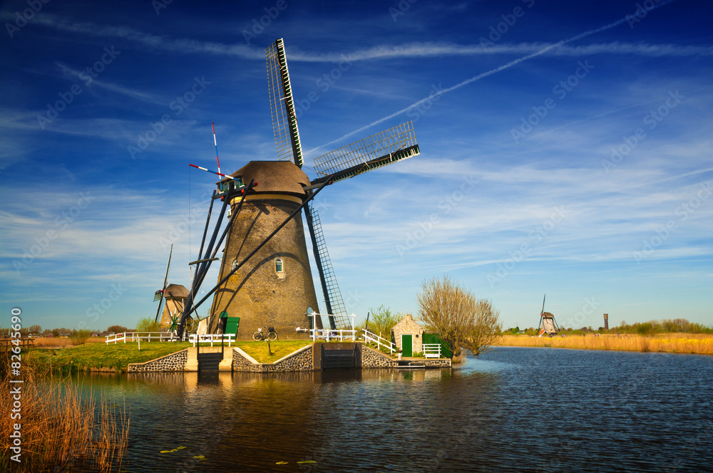  Windmills at riverside on a sunny day, Netherlands