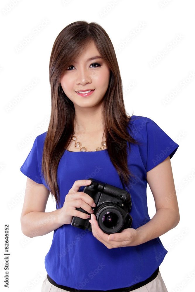 Pretty Asian girl holding a DSLR camera, isolated on white Pretty Asian girl holding a DSLR camera, isolated on white