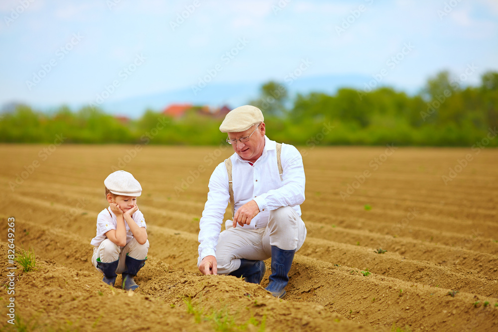 grandpa explaining his grandson the way plants are grow