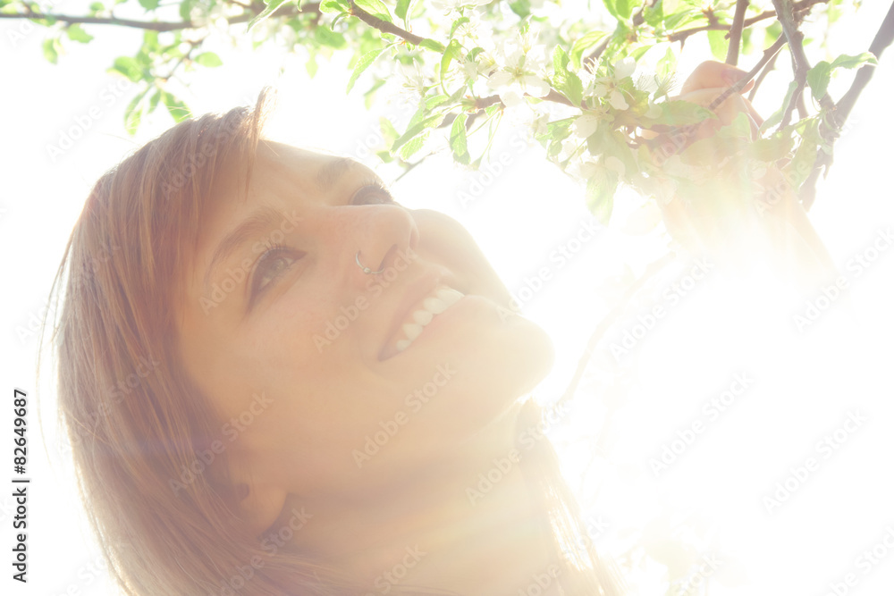 Smiley girl in nature with sun flare.