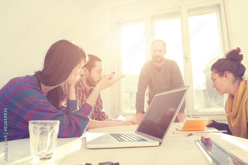 Young group of people discussing business plans. Young group of people discussing business plans.