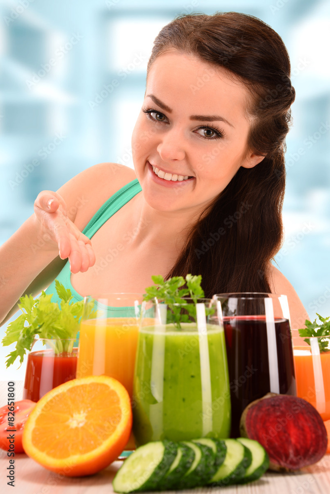 Young woman with variety of vegetable and fruit juices Young woman with variety of vegetable and fruit juices
