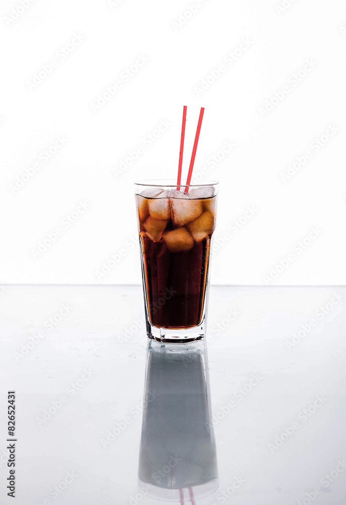 Cola in a glass with ice with red tube. soft drinks Cola in a glass with ice with red tube. soft drinks