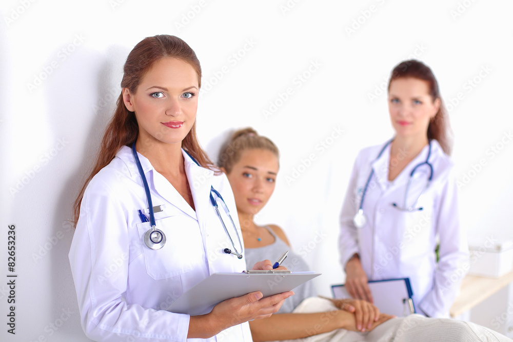 Smiling female doctor with a folder in uniform standing at Smiling female doctor with a folder in uniform standing at