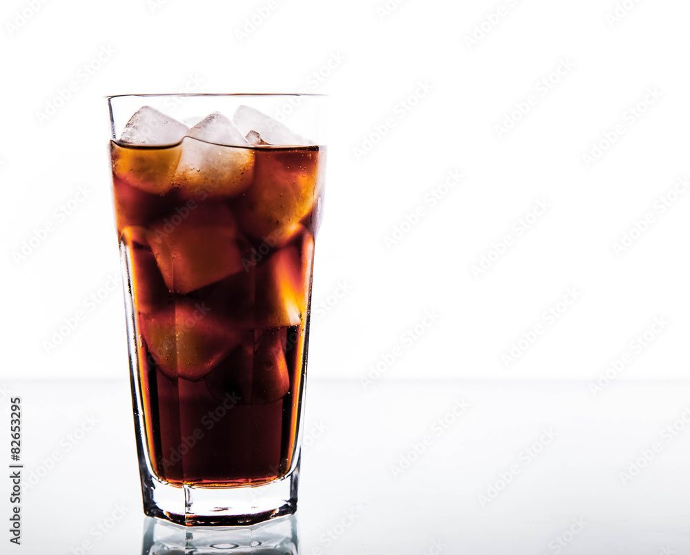 soft drinks. Cola glass with ice cubes on a white background