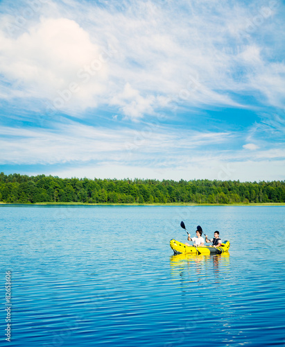 Two Men Paddle a Kayak on Lake. Lifestyle Concept.