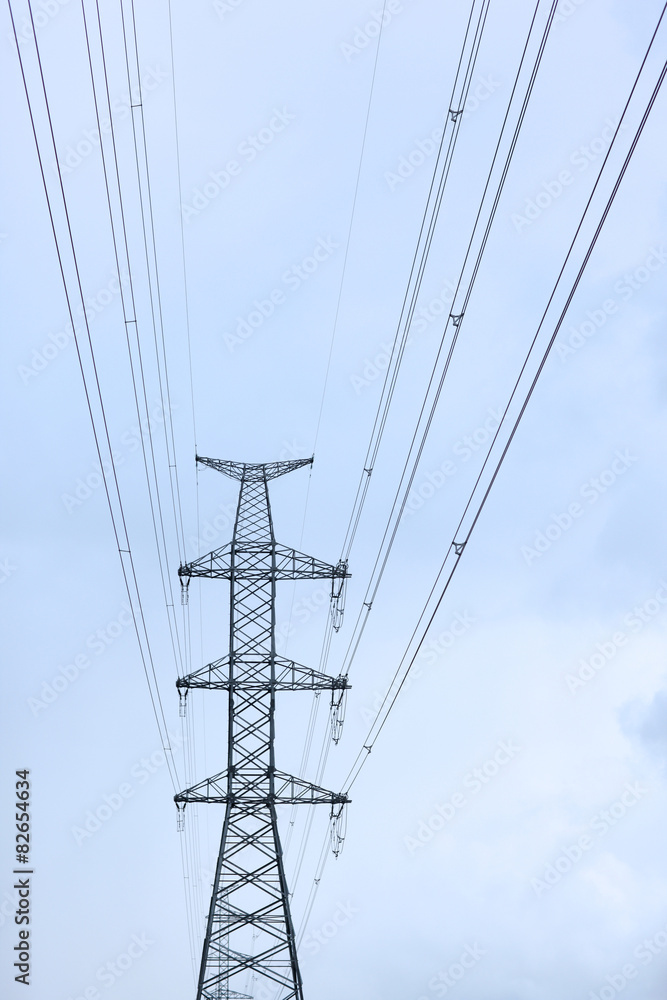 A transmission tower against blue sky