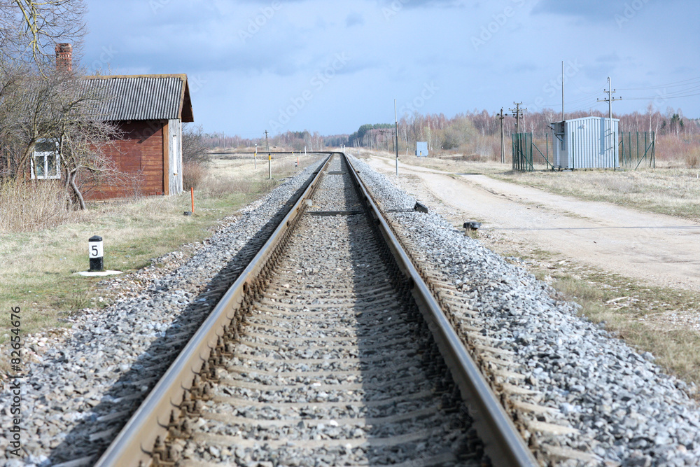 Fototapeta premium Straight section of railway track through country-side