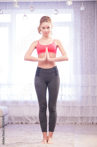Woman standing with hands in Namaste 