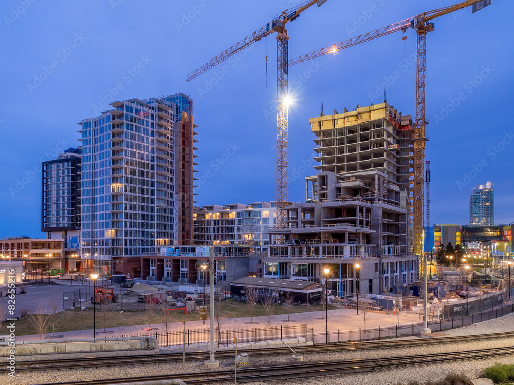Construction cranes over Calgary at night. 