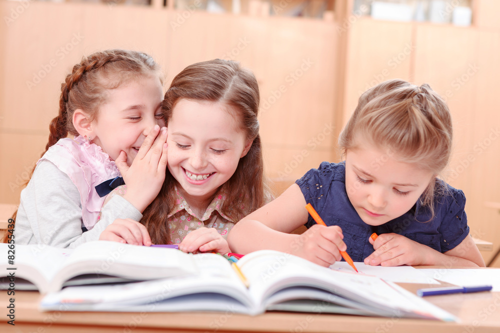 Girls with opened books in classroom Girls with opened books in classroom