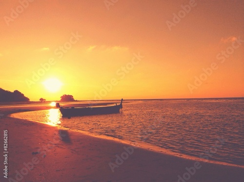 The floating boat with beautiful sunset in vintage sytle © mindmo