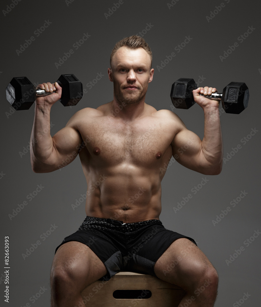 Muscular guy with dumbell