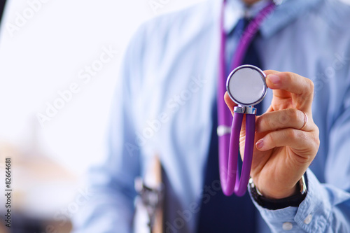 Male doctor with stethoscope listening something