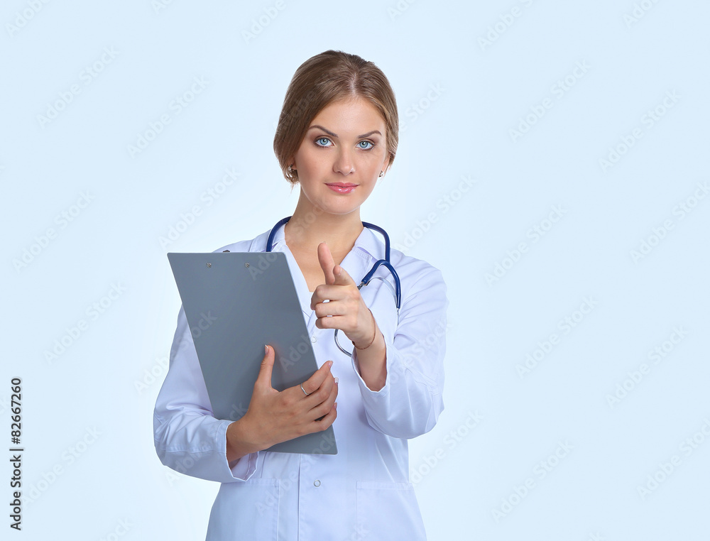 Smiling female doctor with a folder in uniform standing at Smiling female doctor with a folder in uniform standing at