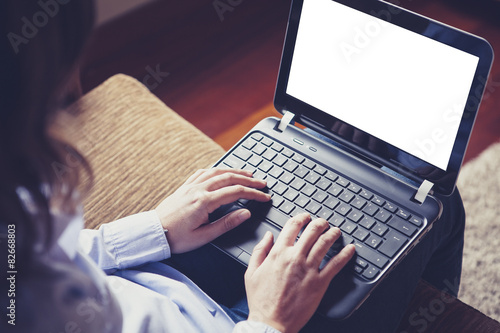 Laptop on the knees. White screen.