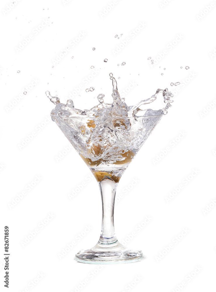 Splash from olive in a glass of cocktail, isolated Splash from olive in a glass of cocktail, isolated
