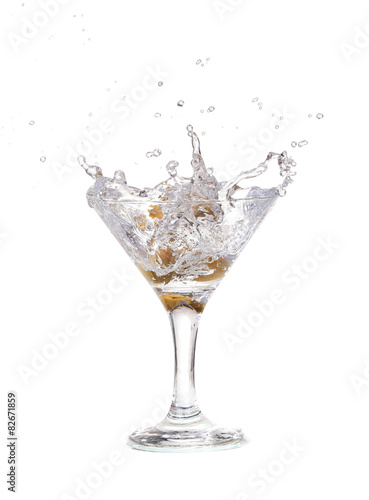 Splash from olive in a glass of cocktail  isolated 