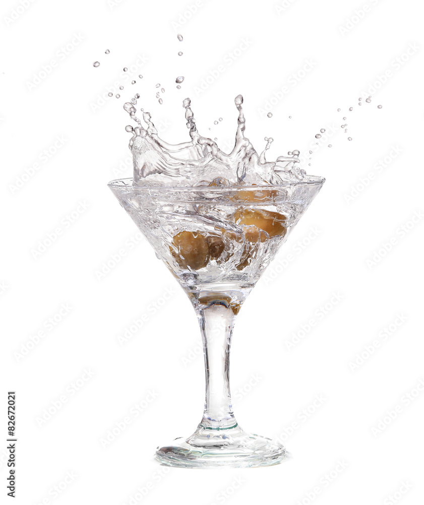Splash from olive in a glass of cocktail, isolated Splash from olive in a glass of cocktail, isolated