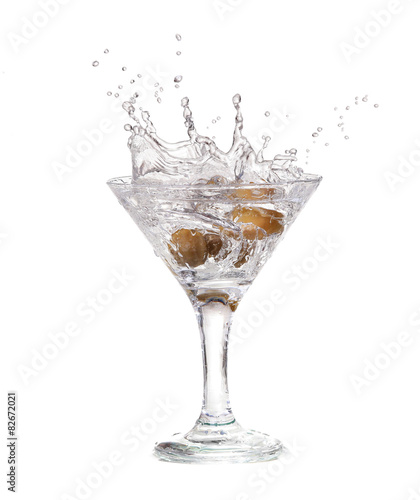 Splash from olive in a glass of cocktail  isolated 