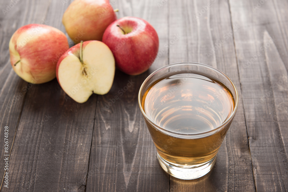 Healthy apple juice drink and red apples fruits on wooden backgr Healthy apple juice drink and red apples fruits on wooden backgr