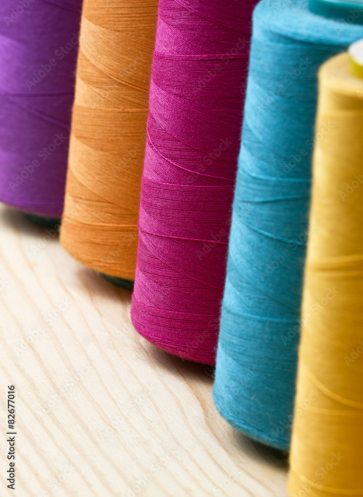 several of multi-colored spool of threads several of multi-colored spool of threads