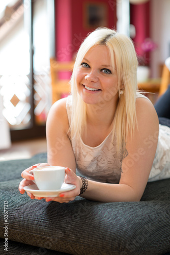 smiling young woman with a coffee cup photo